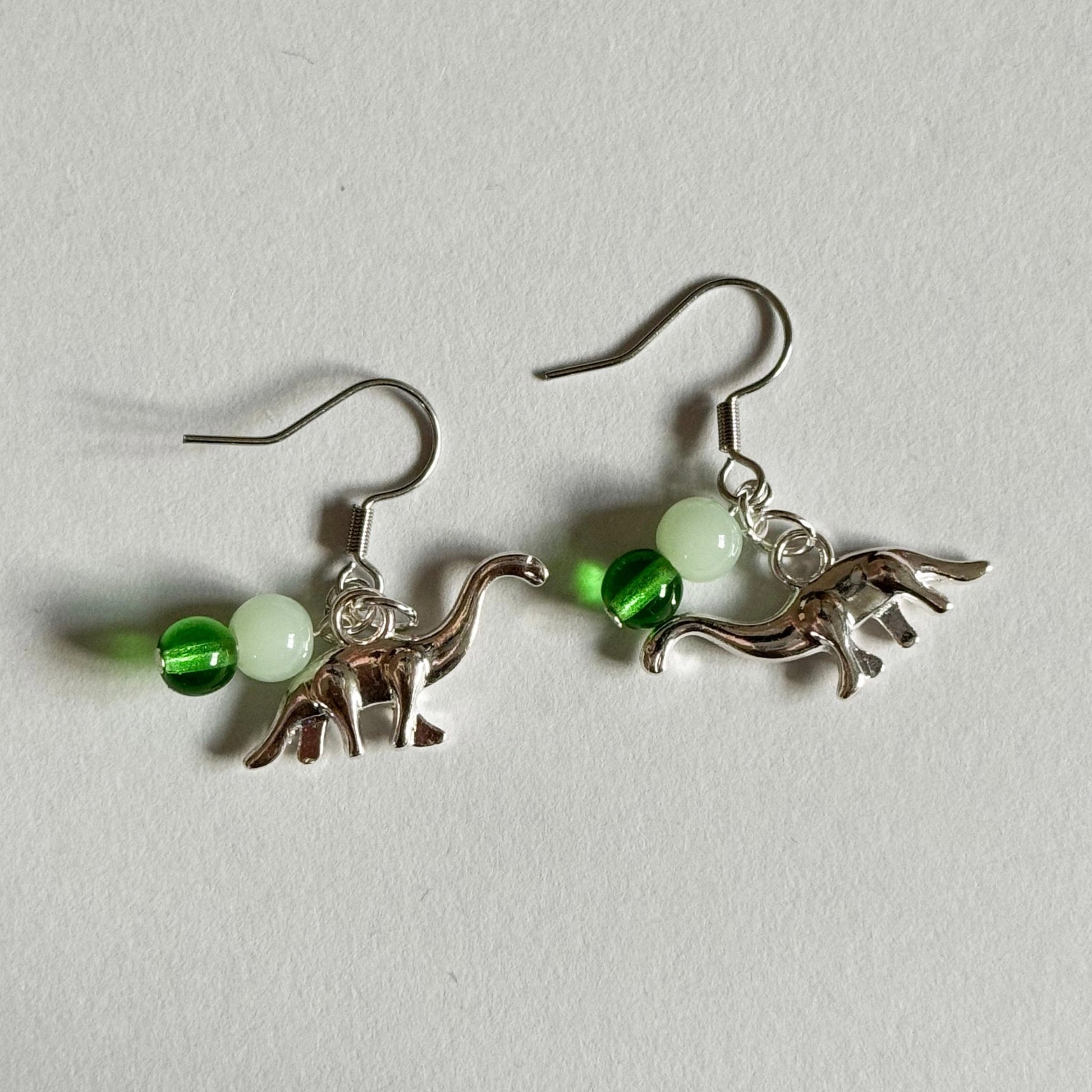 Green dinosaur beaded dangle earrings - Earrings - Made by Saskia