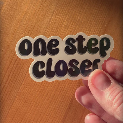 ‘One step closer’ holographic sticker